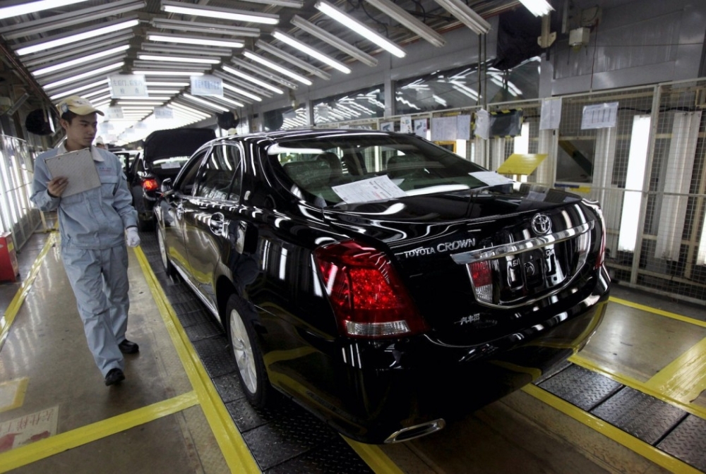 An employee inspects a new Toyota Crown at the Japanese carmaker’s plant in Tianjin, China. — Reuters 