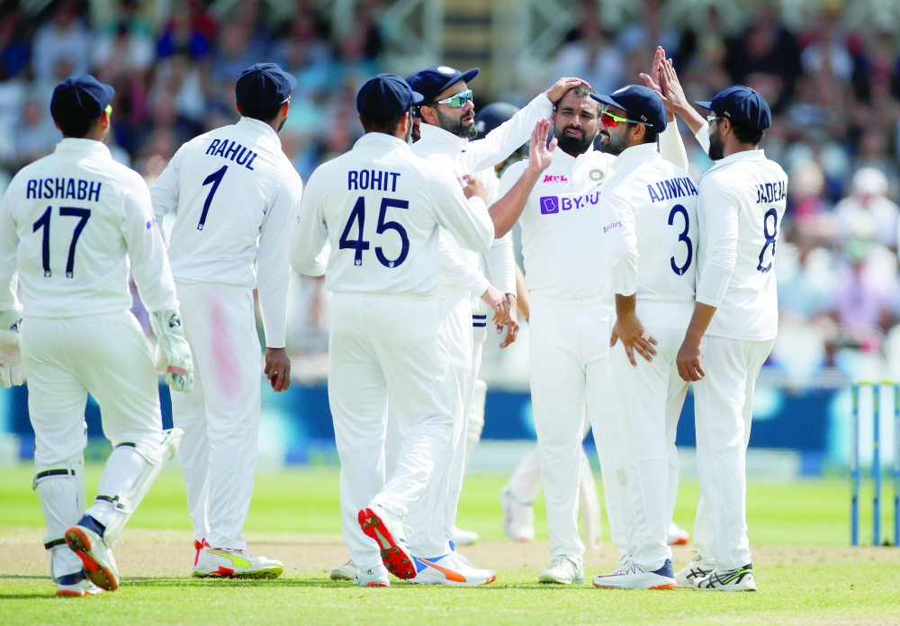 India's Mohammed Shami celebrates taking the wicket of England's Dom Sibley with teammates. -- Reuters