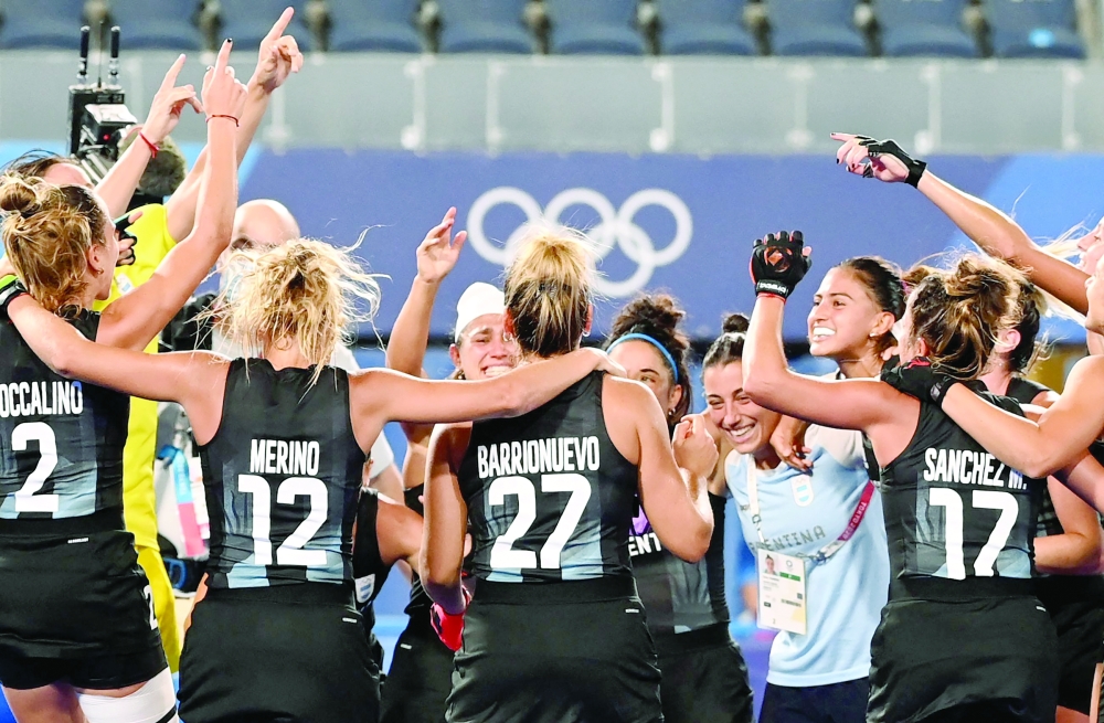 Players of Argentina celebrate after defeating India. -- AFP