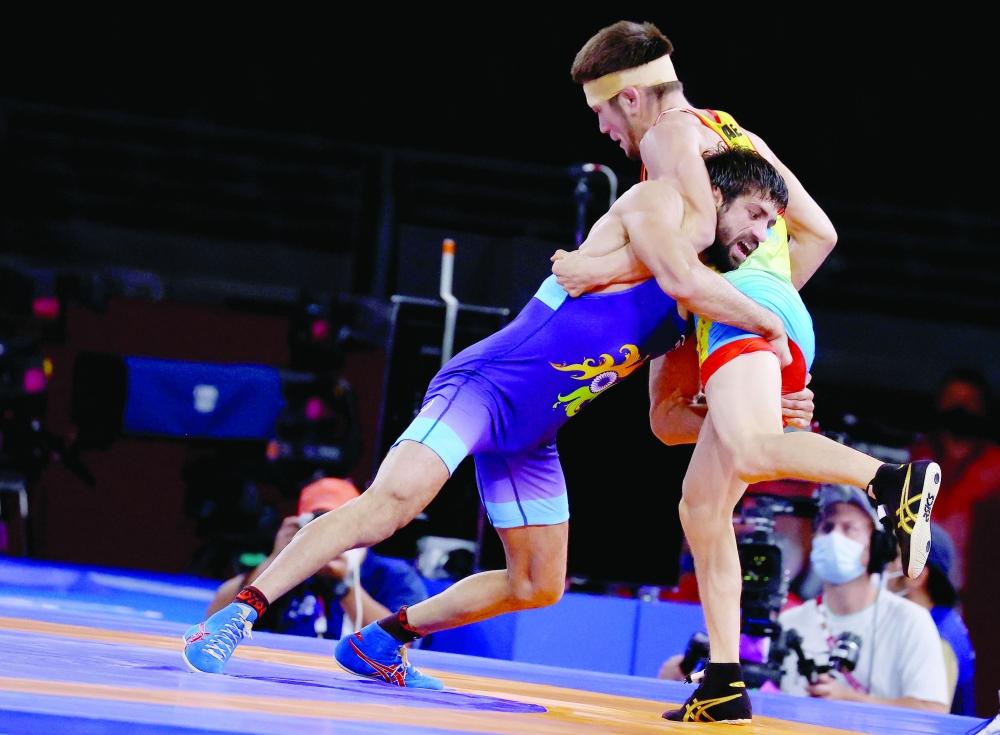 Ravi Kumar of India in action against Nurislam Sanayev of Kazakhstan. -- Reuters