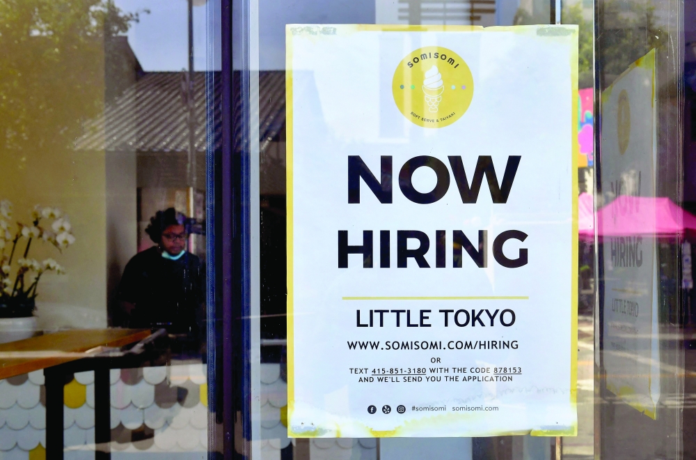 A 'Now Hiring' sign is posted in front of an ice-cream shop in Los Angeles, California. - AFP File Photo 
