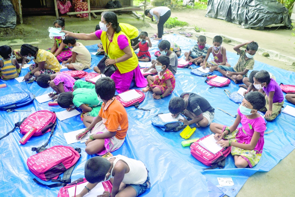 Children of a low-income neighbourhood attend a class at an open-air school 'Vidyachaya' set up by the non-profit Unique Foundation at Porajhar village on the outskirts of Siliguri. - AFP 