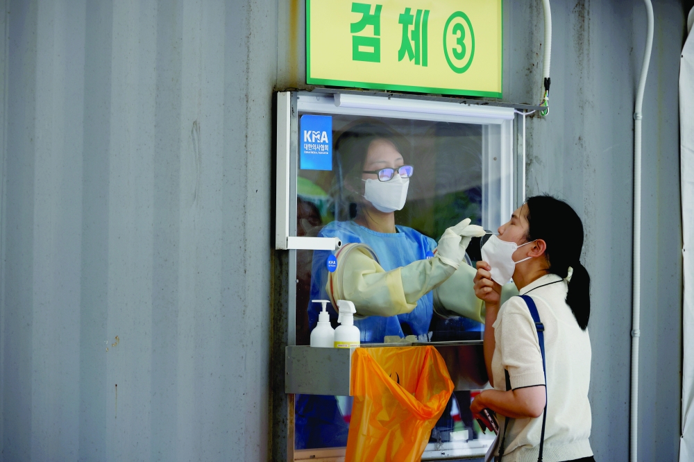 A woman gets a coronavirus test at a coronavirus testing site in Seoul. - Reuters File Photo 