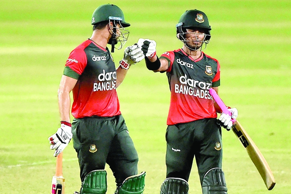 Bangladesh’s Afif Hossain (R) reacts with Nurul Hasan after winning the second T20I against Australia. — AFP