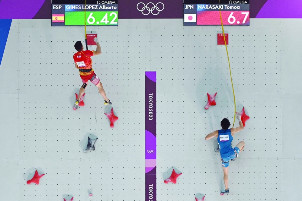 Japan's Tomoa Narasaki (R) is defeated by Spain's Alberto Gines Lopez in their men's sport climbing speed finals. -- AFP 