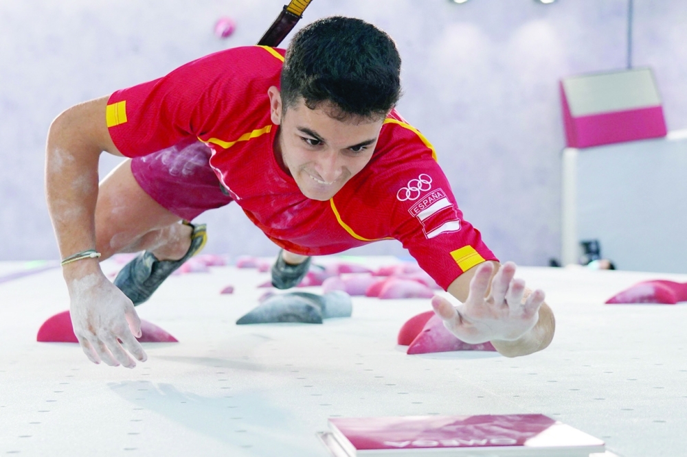 Spain's Alberto Gines Lopez hits the button and wins his men's sport climbing speed final against Japan's Tomoa Narasaki. -- AFP 
