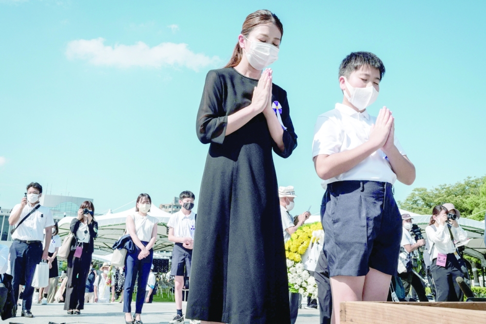 People pray at the Hiroshima Peace Memorial Park in Hiroshima following the annual ceremony to remember the victims on the 76th anniversary of the world's first atomic bomb attack. - AFP

