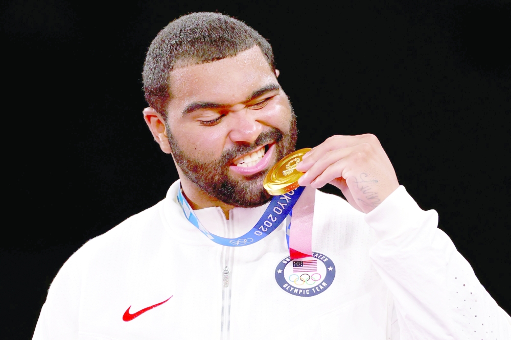 Gold medalist USA's Gable Dan Steveson poses with his medal on the podium. -- AFP