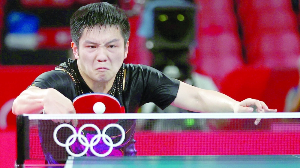 Fan Zhendong of China in action against Dimitrij Ovtcharov of Germany. -- Reuters