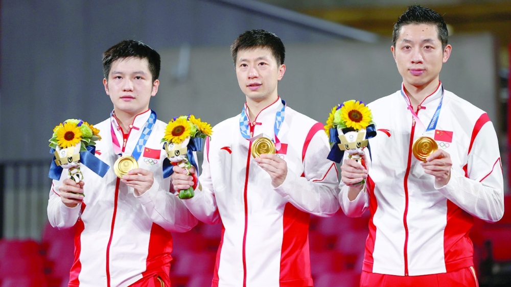 Gold medallists Fan Zhendong of China, Ma Long of China and Xu Xin of China on the podium. -- Reuters