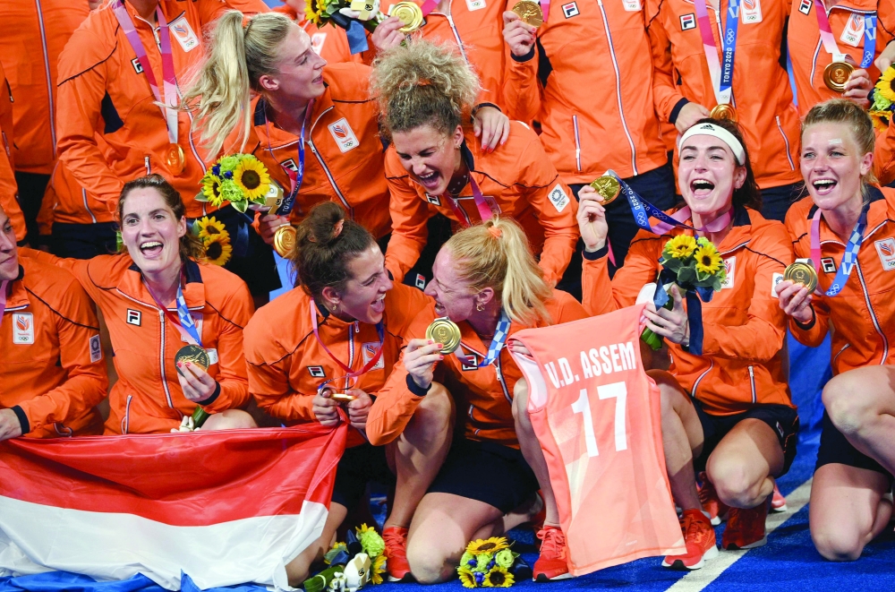 Netherlands' gold medallists celebrate during the medal ceremony of the Tokyo 2020 Olympic Games women's field hockey competition. -- AFP