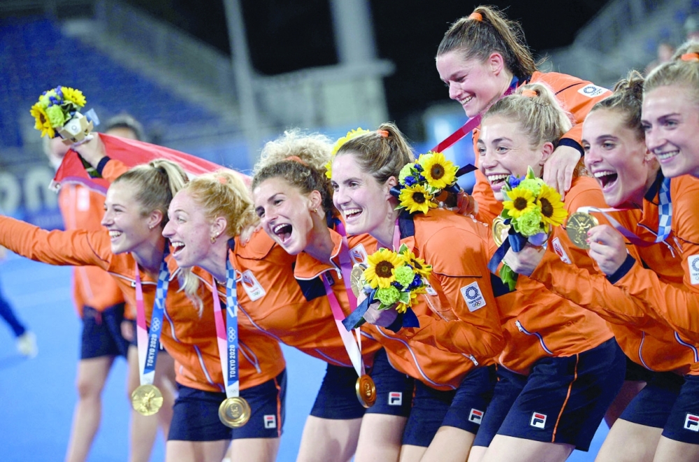 Netherlands' gold medallists celebrate after the medal ceremony of the Tokyo 2020 Olympic Games women's field hockey competition, at the Oi Hockey Stadium in Tokyo. -- AFP