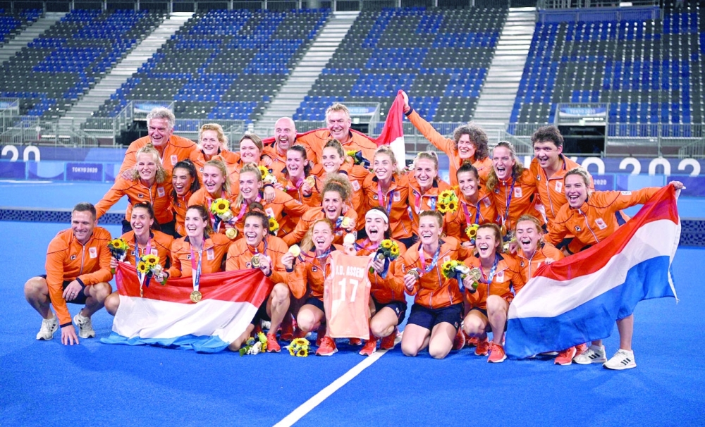 Netherlands' gold medallists celebrate during the medal ceremony of the Tokyo 2020 Olympic Games women's field hockey competition. -- AFP