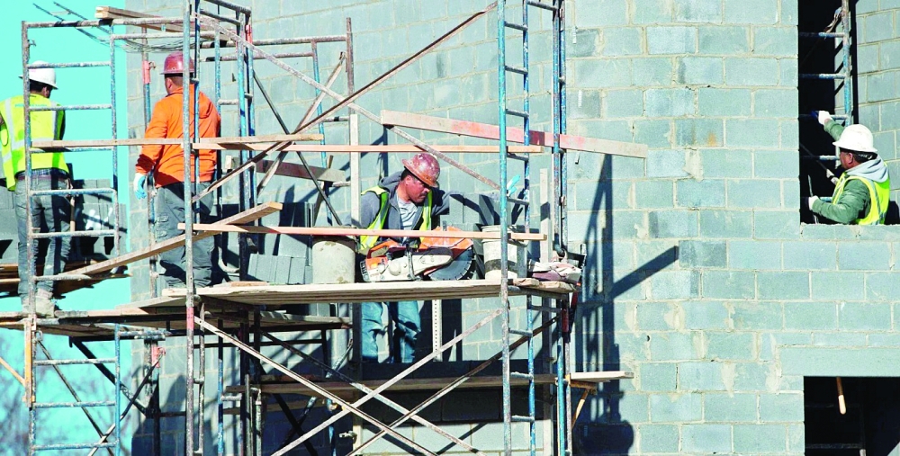 Construction workers are seen as they build an apartment building in Fairfax, Virginia.  — AFP