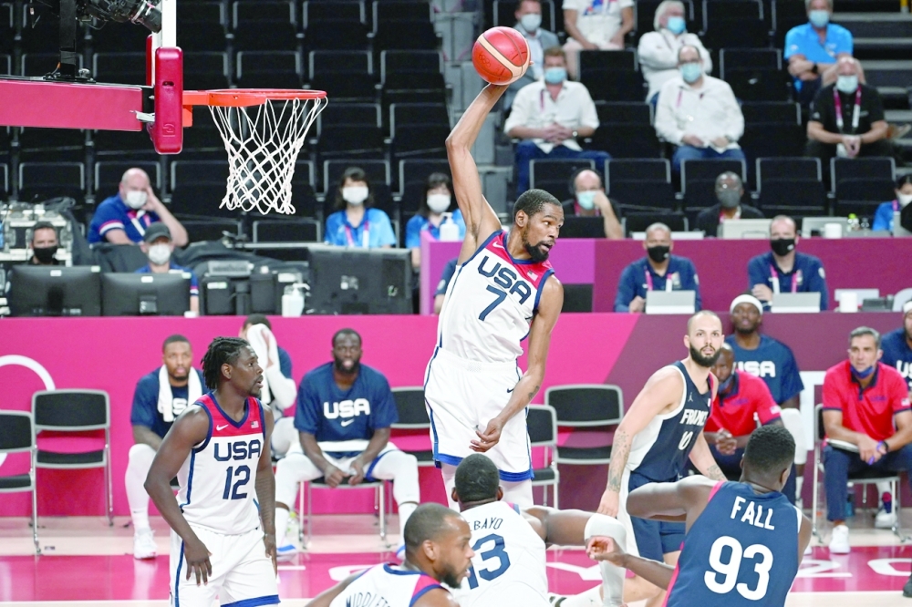 USA's Kevin Wayne Durant jumps for the rebound in the men's final basketball match between France and USA during the Tokyo 2020 Olympic Games at the Saitama Super Arena in Saitama. -- AFP

