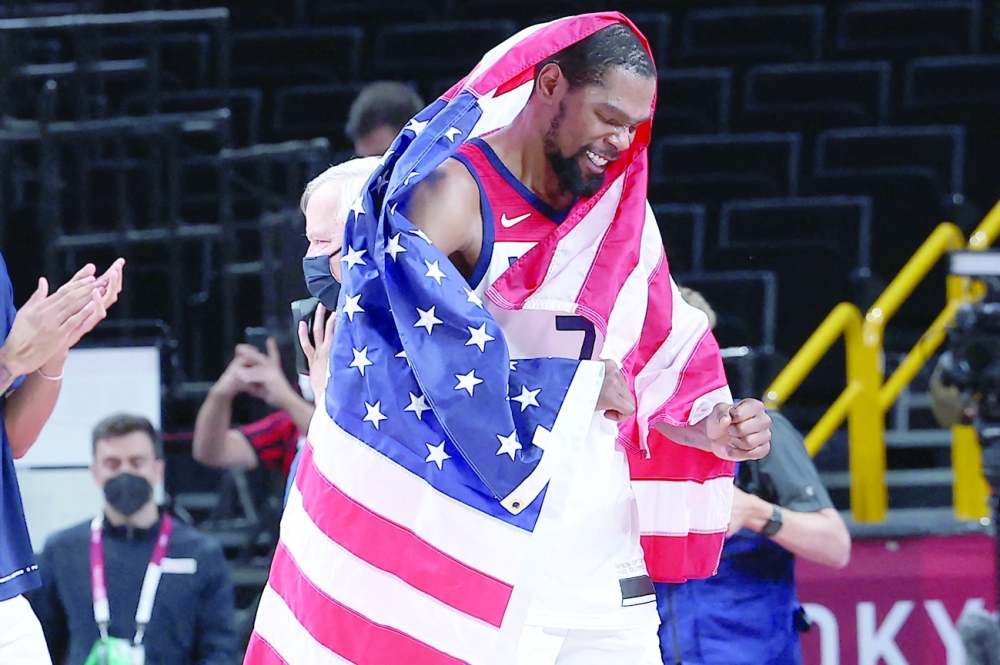USA's Kevin Wayne Durant carries national flag while celebrating his team's win. -- AFP


