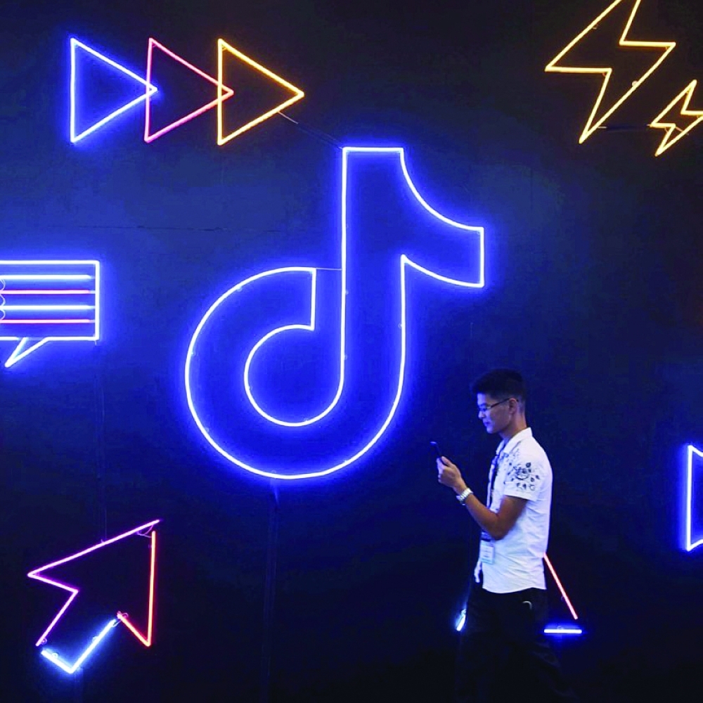 A man walks past Tiktok logo in Beijing, in this file photo. — Reuters