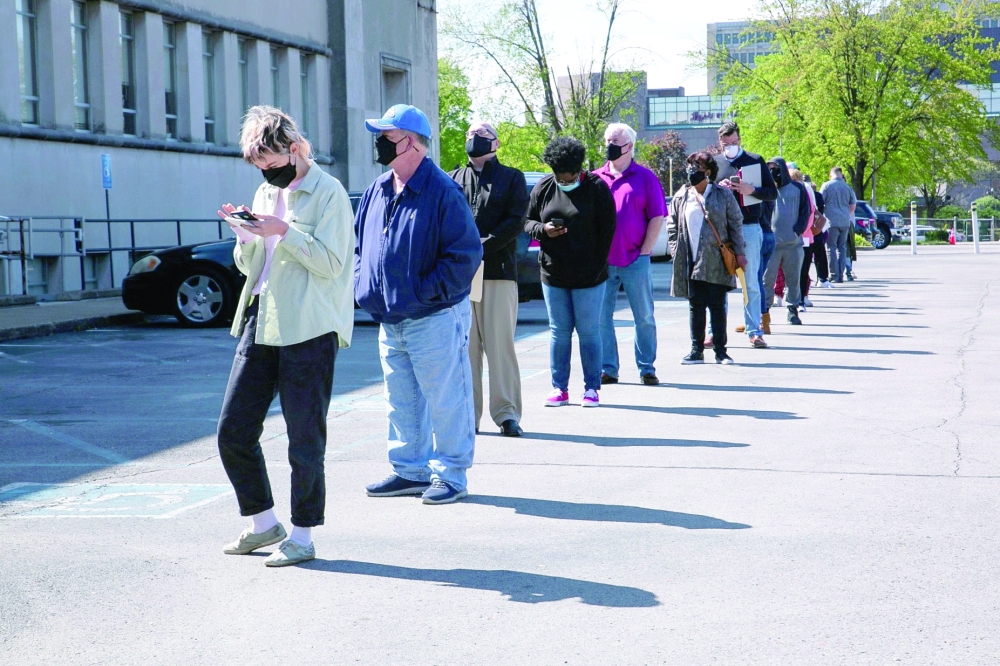 People line up outside a newly reopened career center for in-person appointments in Louisville, Kentucky. — Reuters
