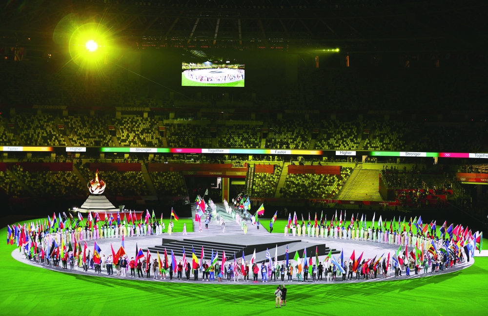 General view of flag bearers and the Olympic flame and cauldron at the closing ceremony of Tokyo 2020 Olympics. -- Reuters