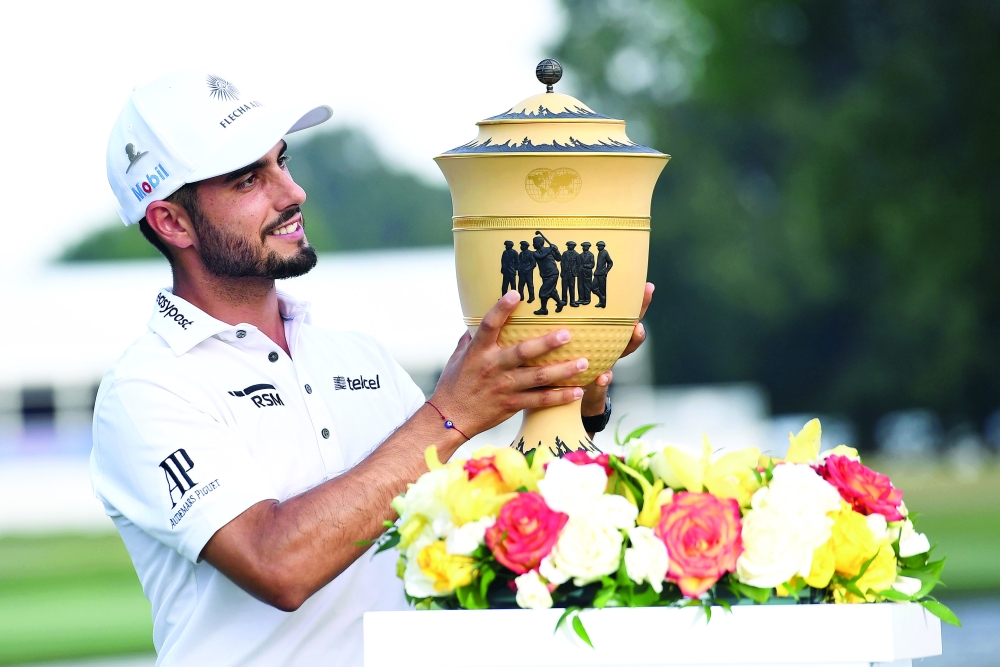 Abraham Ancer poses with the Gary Player Cup after winning WGC FedEx St. Jude Invitational tournament at TPC Southwind in a two hole playoff. -- USA Today Sports
