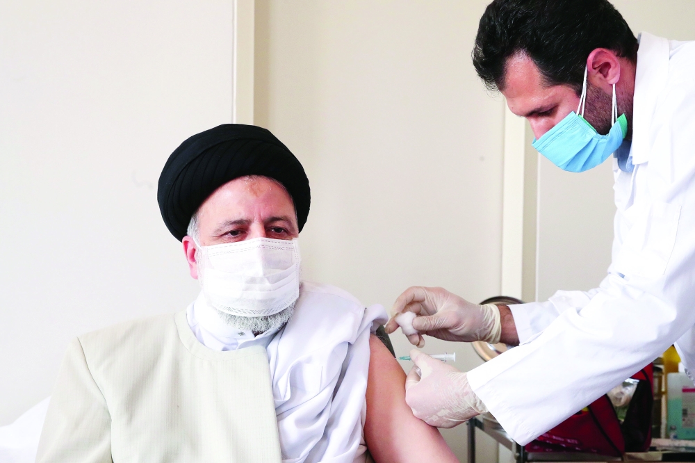 Iran's President Ebrahim Raisi receives the first dose of the Iranian CV-vaccine against coronavirus disease  in Tehran on Sunday. -- Reuter