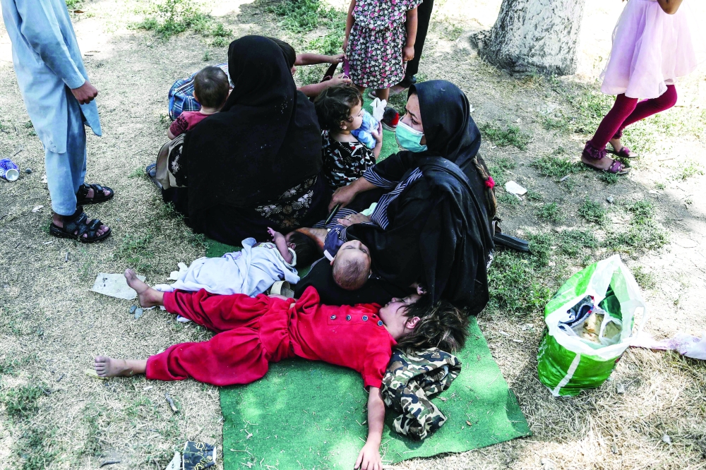 Internally displaced Afghan families, who fled from Kunduz and Takhar province due to battles between Taliban and Afghan security sit at the Shahr-e-Naw Park in Kabul on Tuesday.  -- AFP