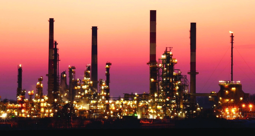 The chimneys of the Total Grandpuits oil refinery are seen just after sunset in southeast of Paris, France. — Reuters