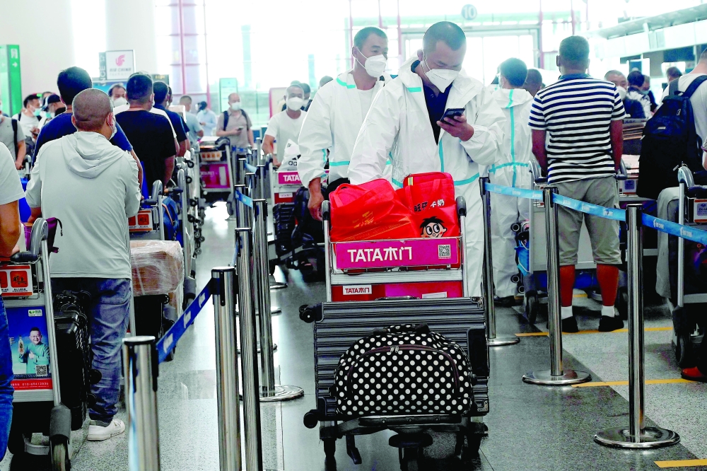 Travellers at the check-in area at Beijing痴 Capital international airport on Tuesday. -- AFP
