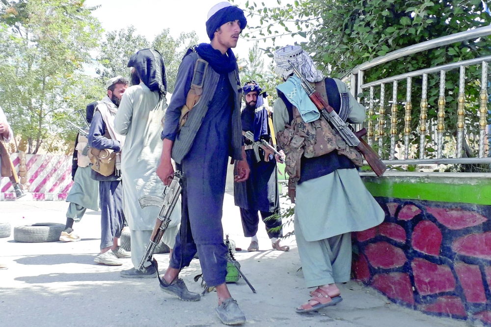 Taliban fighters stand along the roadside in Ghazni as Taliban move closer to Afghan capital after taking Ghazni city. - AFP
