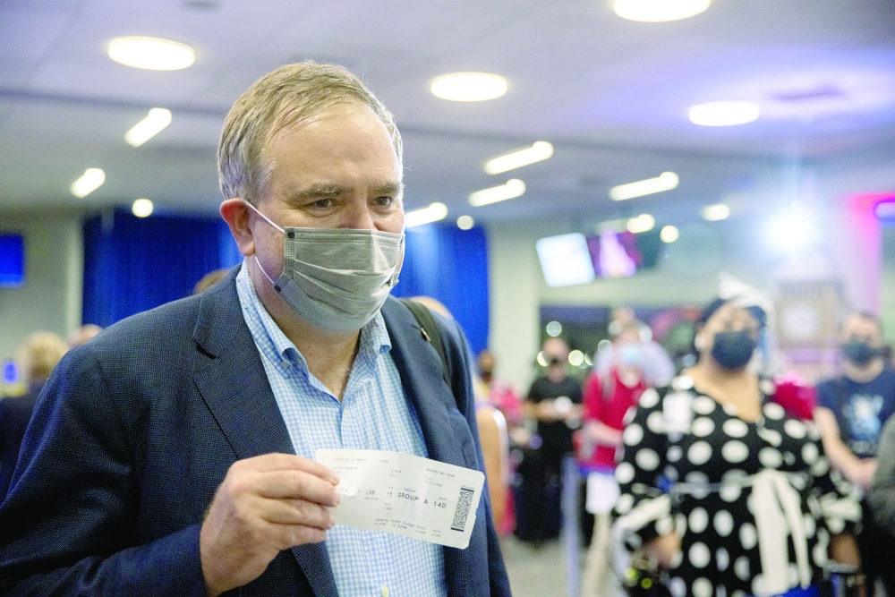 JetBlue CEO Robin Hayes shows his flight ticket before a JetBlue flight to London at JFK International Airport in the Queens borough of New York City. - Reuters

