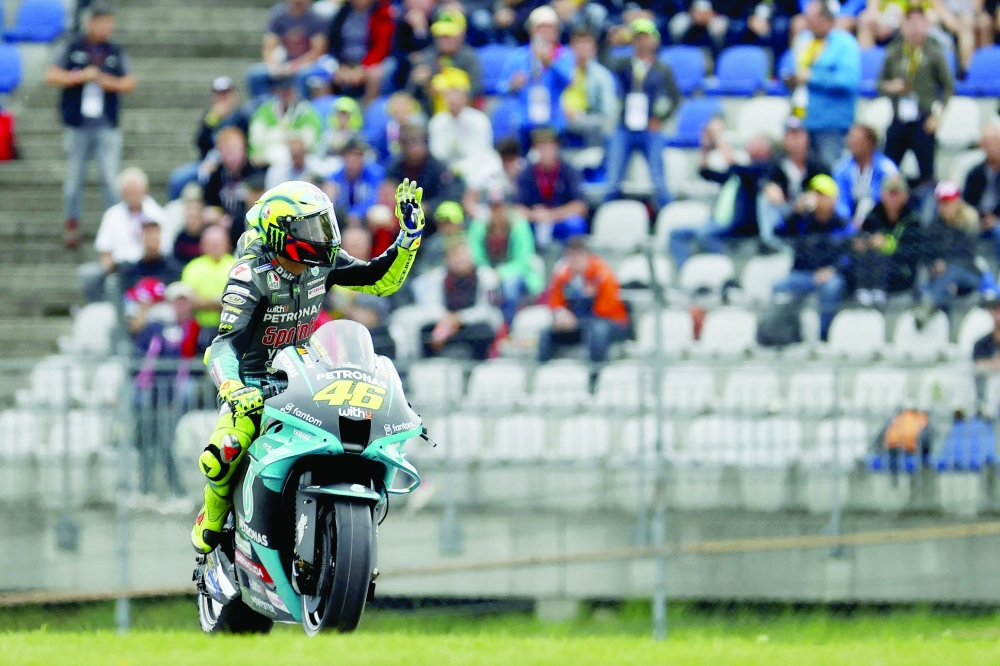 Yamaha-SRT Italian rider Valentino Rossi waves to fans during the Styrian MotoGP in Spielberg, Austria. -- AFP