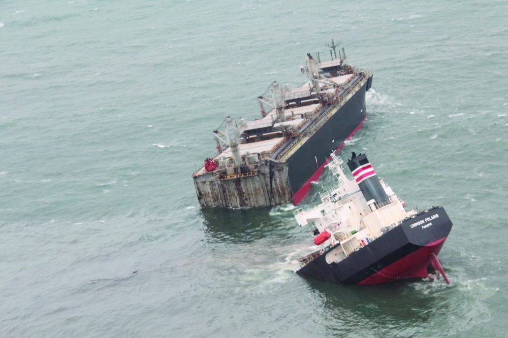 Aerial images shows the separated stern of the Crimson Polaris tipped upwards. -- AFP