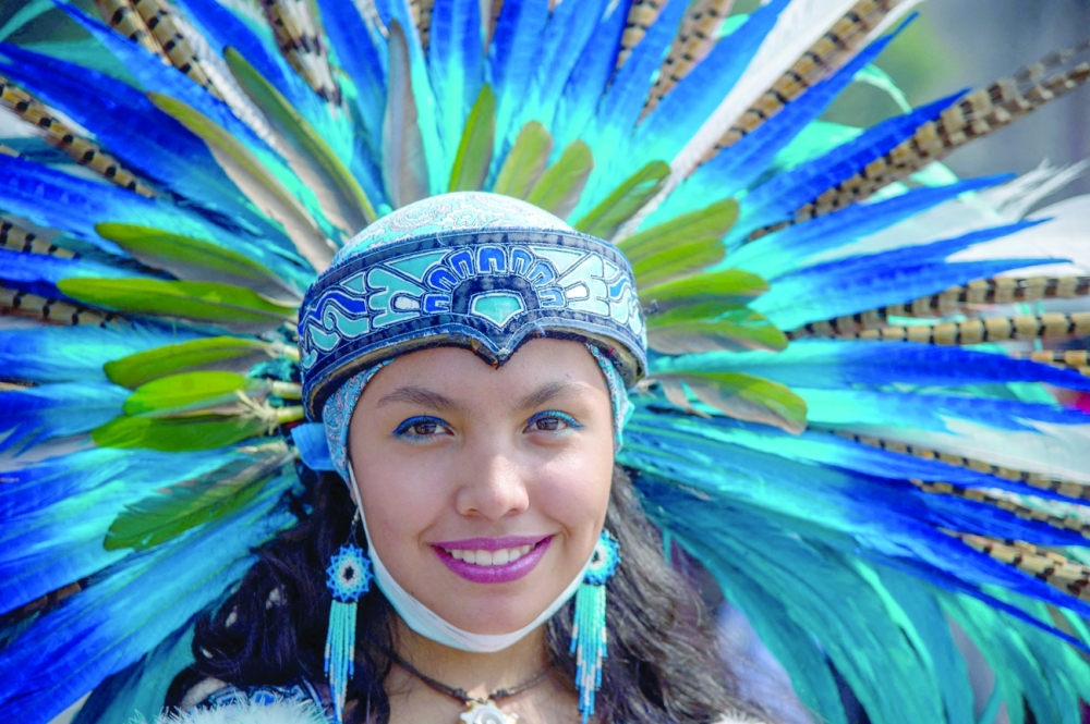 A woman wearing a plume takes part in the celebration of the 500 anniversary of the last day of indigenous domain ahead of the fall of Tenochtitlan to the Spanish at the Zocalo square. Mexico City authorities have announced a series of cultural events to take place throughout the year to mark the anniversary of the fall of capital of the Aztec Empire and the city’s founding by the Spanish. -- AFP