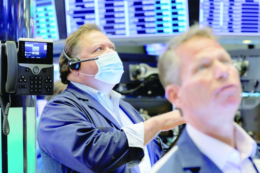 Traders work on the trading floor at the New York Stock Exchange (NYSE) in Manhattan, New York City. - Reuters,