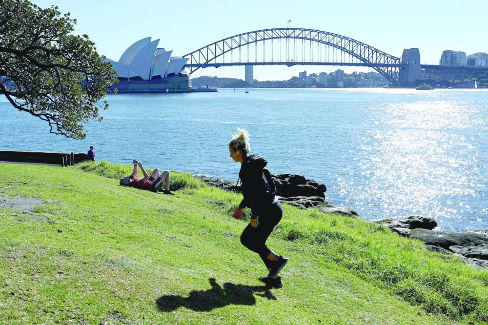 Visitors spend their afternoon at Mrs Macquarie's Point amid an extended lockdown due to the Covid-19 pandemic in Sydney. - AFP
