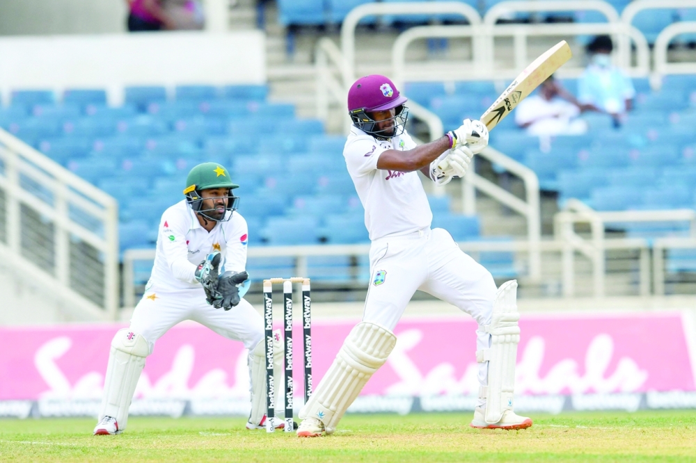 Kraigg Brathwaite (R) of West Indies hits a boundary at Sabina Park, Kingston, Jamaica. -- AFP