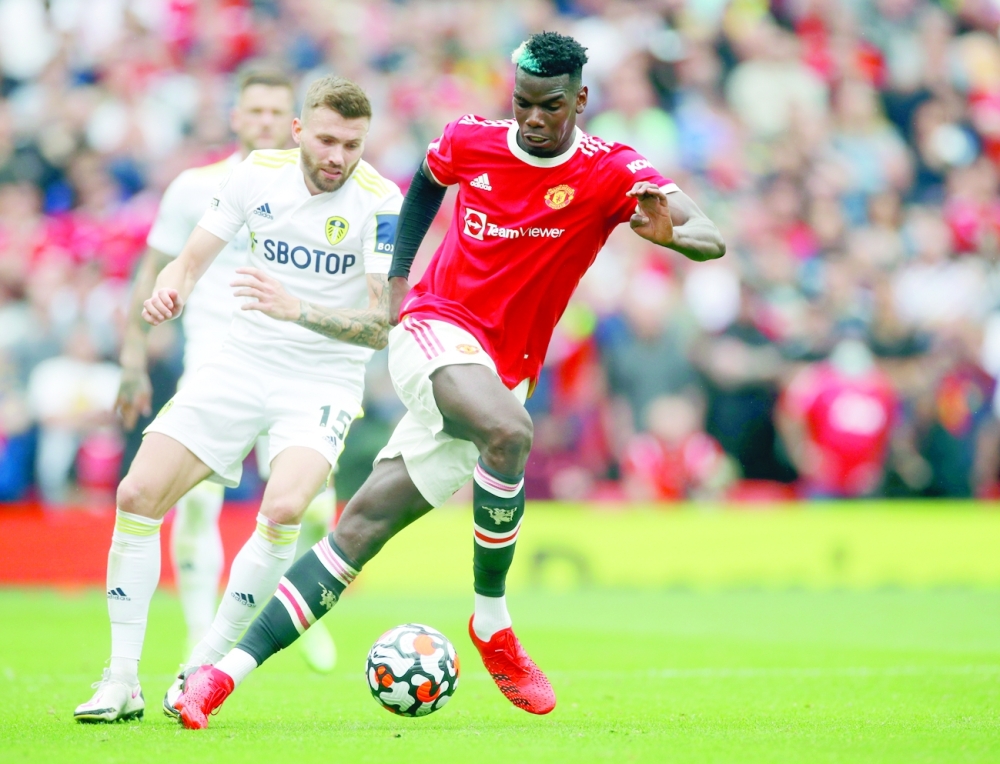 Leeds United's Stuart Dallas in action with Manchester United's Paul Pogba. -- Reuters