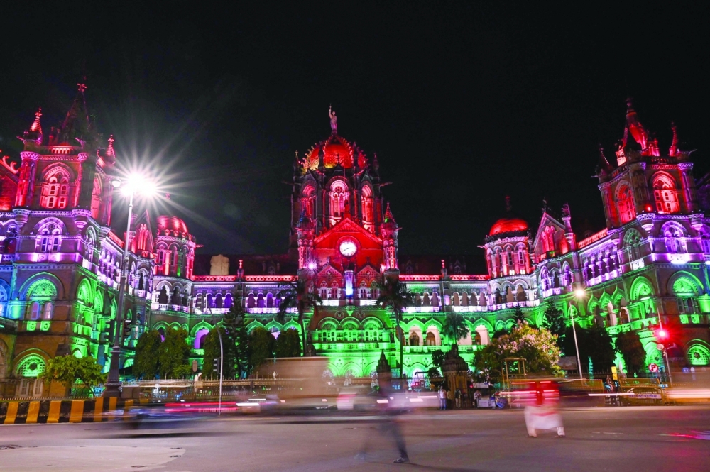 The Chatrapati Shivaji Railway terminus is seen lit up with India's national flag colours on the eve of the country's 75th Independence Day celebrations in Mumbai on Sunday. - AFP