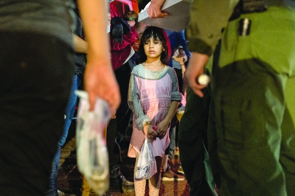 An unaccompanied 4 year-old migrant from Honduras waits to be transported by the US Border Patrol after crossing the Rio Grande river into the United States from Mexico in Roma, Texas on Sunday. -- Reuters