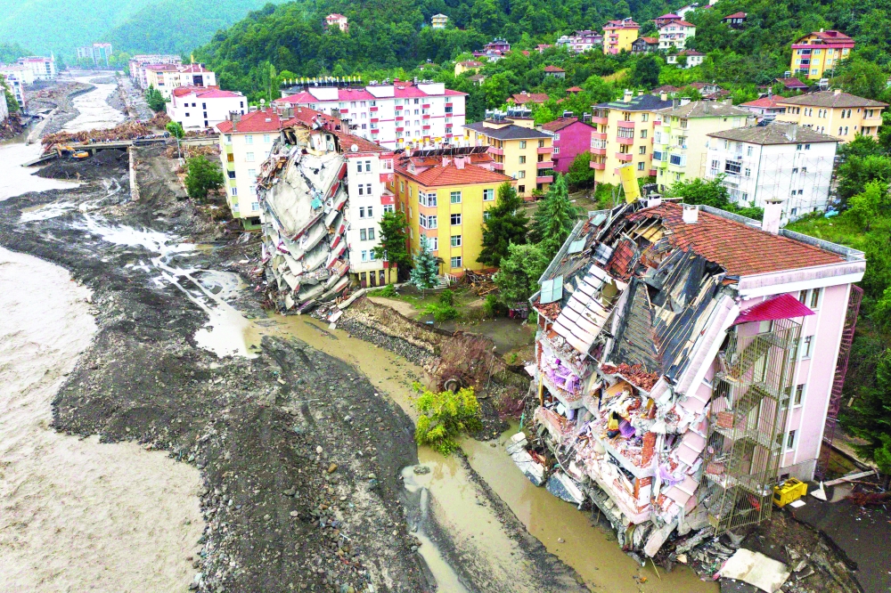 An aerial view shows damaged buildings close to the Ezine Stream after deadly flash floods broke it's banks in Bozkurt town in the district of Kastamonu on Sunday. -- AFP