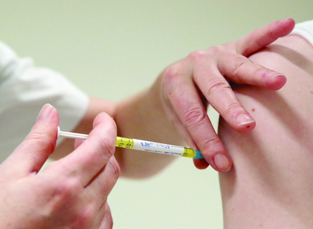 A volunteer receives a dose of CureVac vaccine or a placebo during a study by the German biotech firm CureVac as part of a testing for a new vaccine against the coronavirus disease (COVID-19), in Brussels. -- Reuters