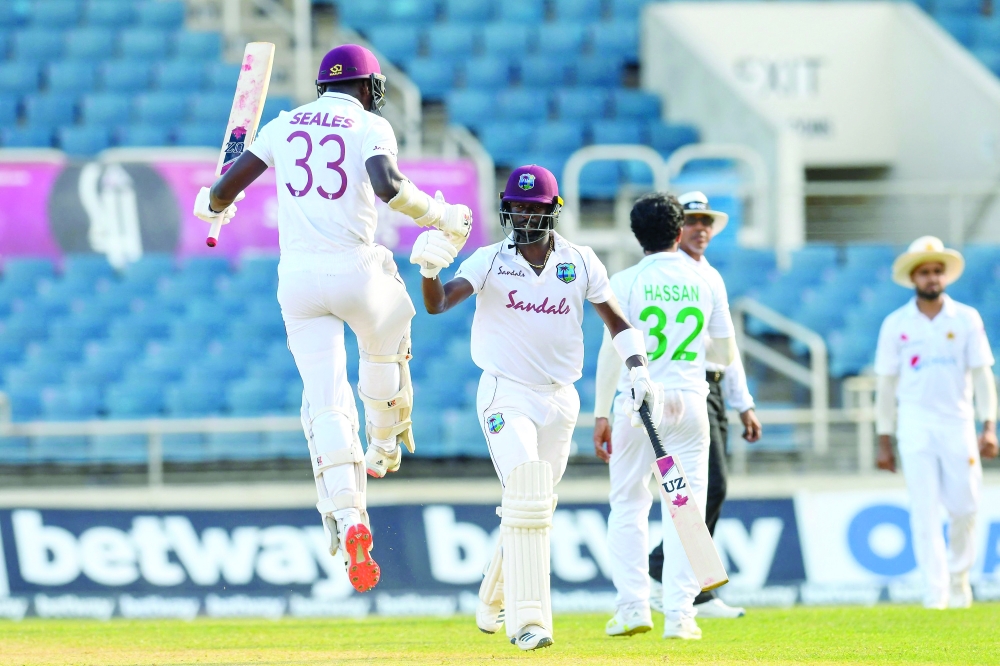Jayden Seales (L) and Kemar Roach (2L) of West Indies celebrate after beating Pakistan at Sabina Park, Kingston. -- AFP