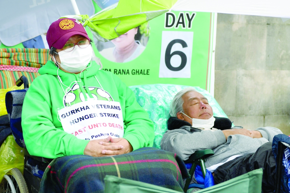 Support Our Gurkhas protesters Pushpa Rana Ghale (L) and Gyanraj Rai continue their hunger strike as they demonstrate for equal pensions outside Downing Street in central London. -- AFP