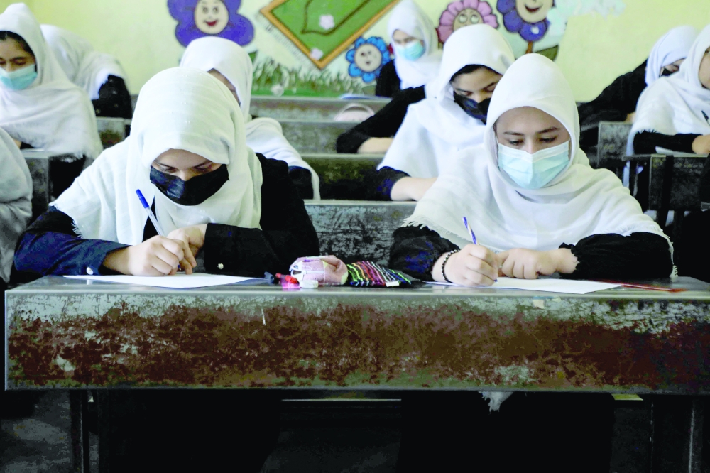 Schoolgirls attend class in Herat on Tuesday. -- AFP