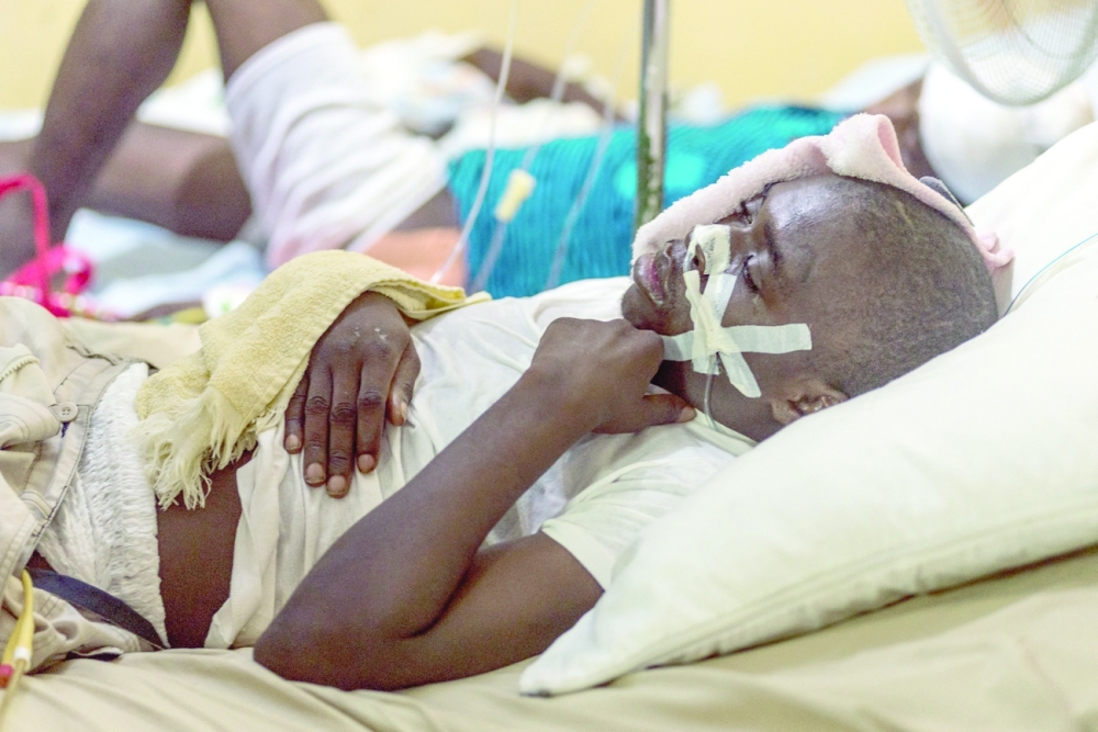 A young man seriously injured by the earthquake lies on a bed at hospital in Port-Salut in Port-Salut, Haiti. - AFP