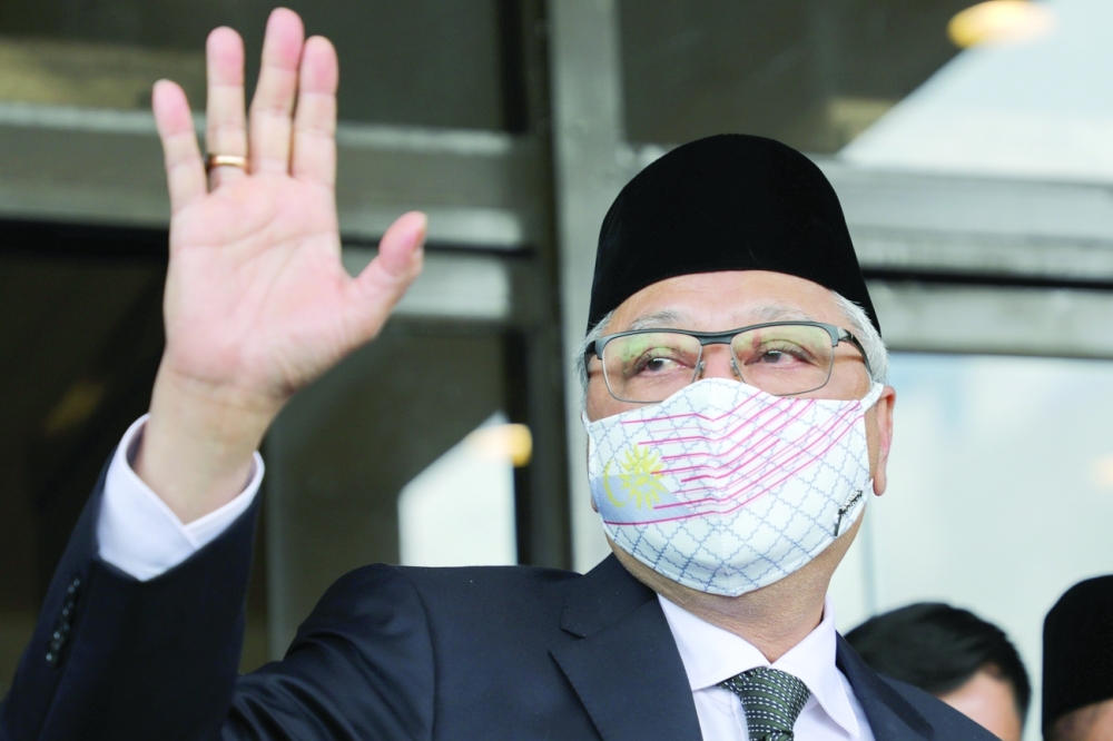 Former Malaysian Deputy Prime Minister Ismail Sabri Yaakob waves before departing for a meeting with the King in Kuala Lumpur. - Reuters