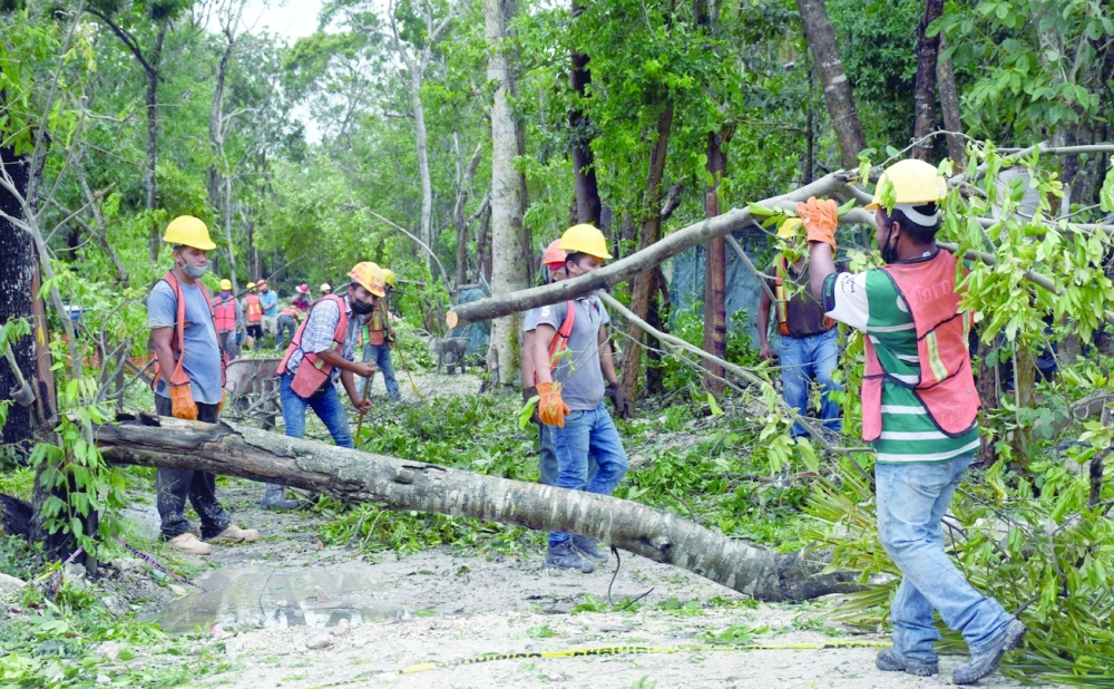Local workers clean the streets after the passage of Hurricane Grace through the coast of Tulum, state of Quintana Roo, Mexico. - AFP