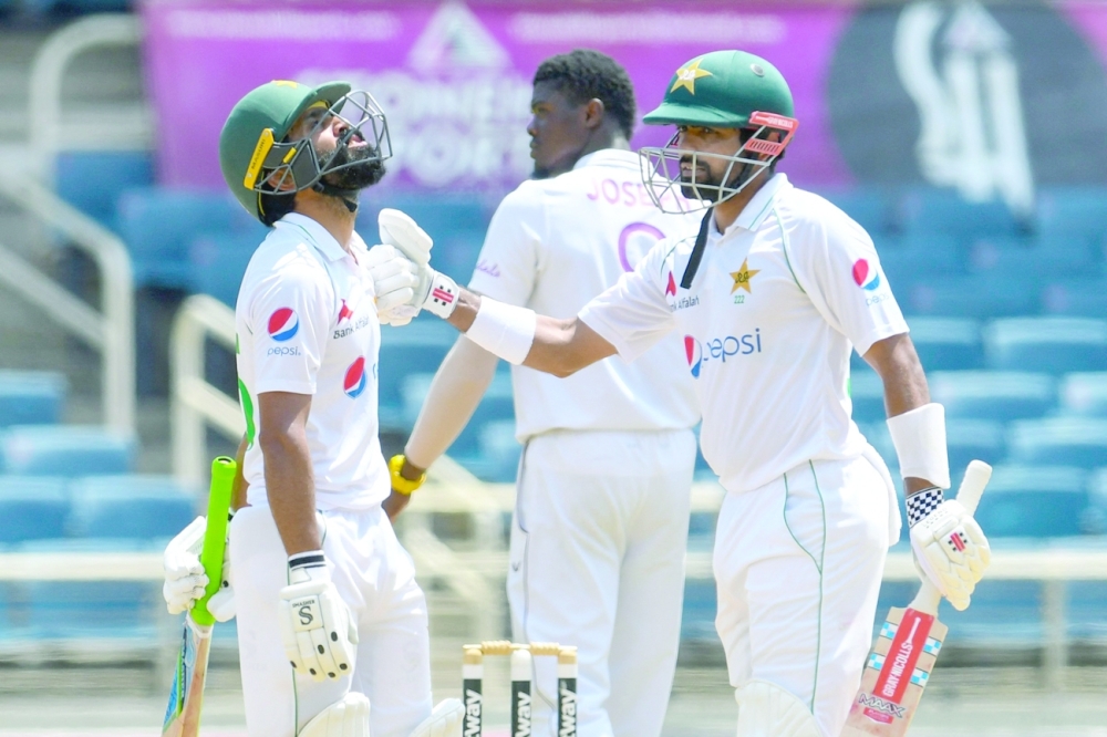 Fawad Alam (L) and Babar Azam (R) of Pakistan during their hundren run partnership. -- AFP