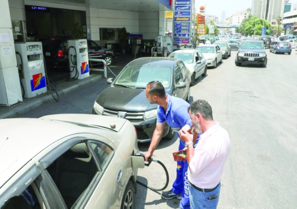 A worker fills up a car with fuel at a gas station in Beirut.  — Reuters