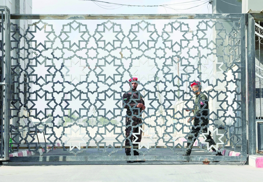 Members of Palestinan security forces stand guard at the closed off Rafah border crossing to Egypt in the southern Gaza Strip, on Monday. -- AFP